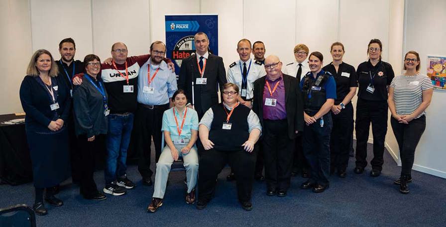 Group photo including Learning Disability Ambassadors and representatives from the Emergency Services during the Our Home, Our Life event in 2022.