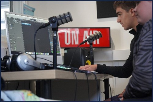 Young people using audio recording equipment and microphone