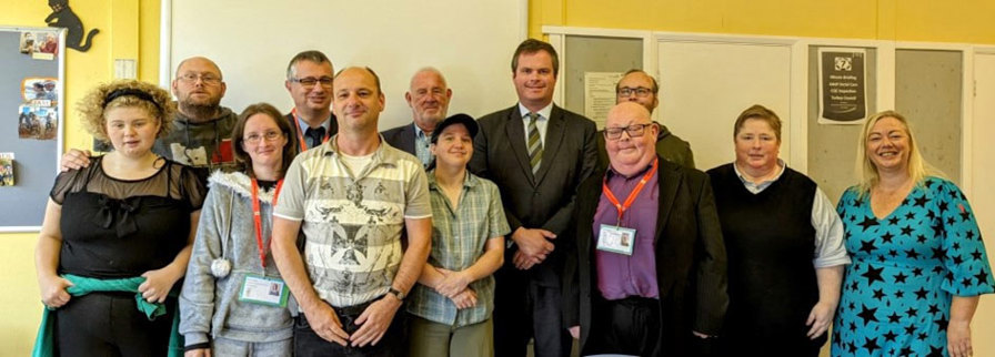 Group photo including Learning Disability Ambassadors and representatives from Torbay Council and Kevin Foster MP.