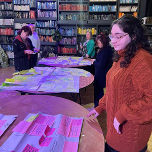 People looking at post it notes during a mental health co-production session.