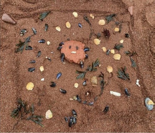 Small stones arranged decoratively on the beach.