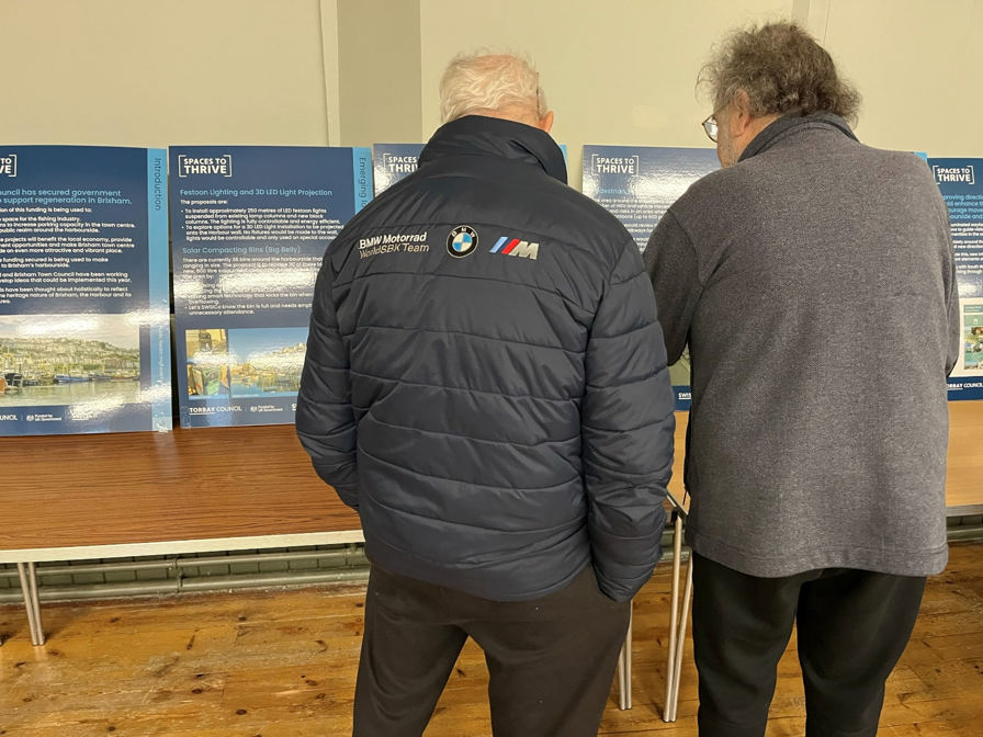 Two men looking at information boards of the proposal.