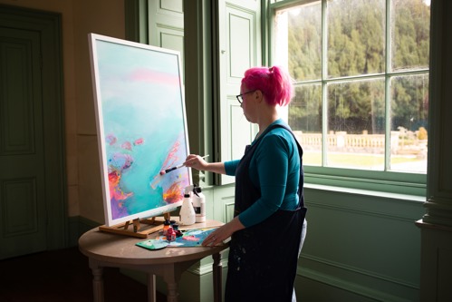 Woman painting a picture.