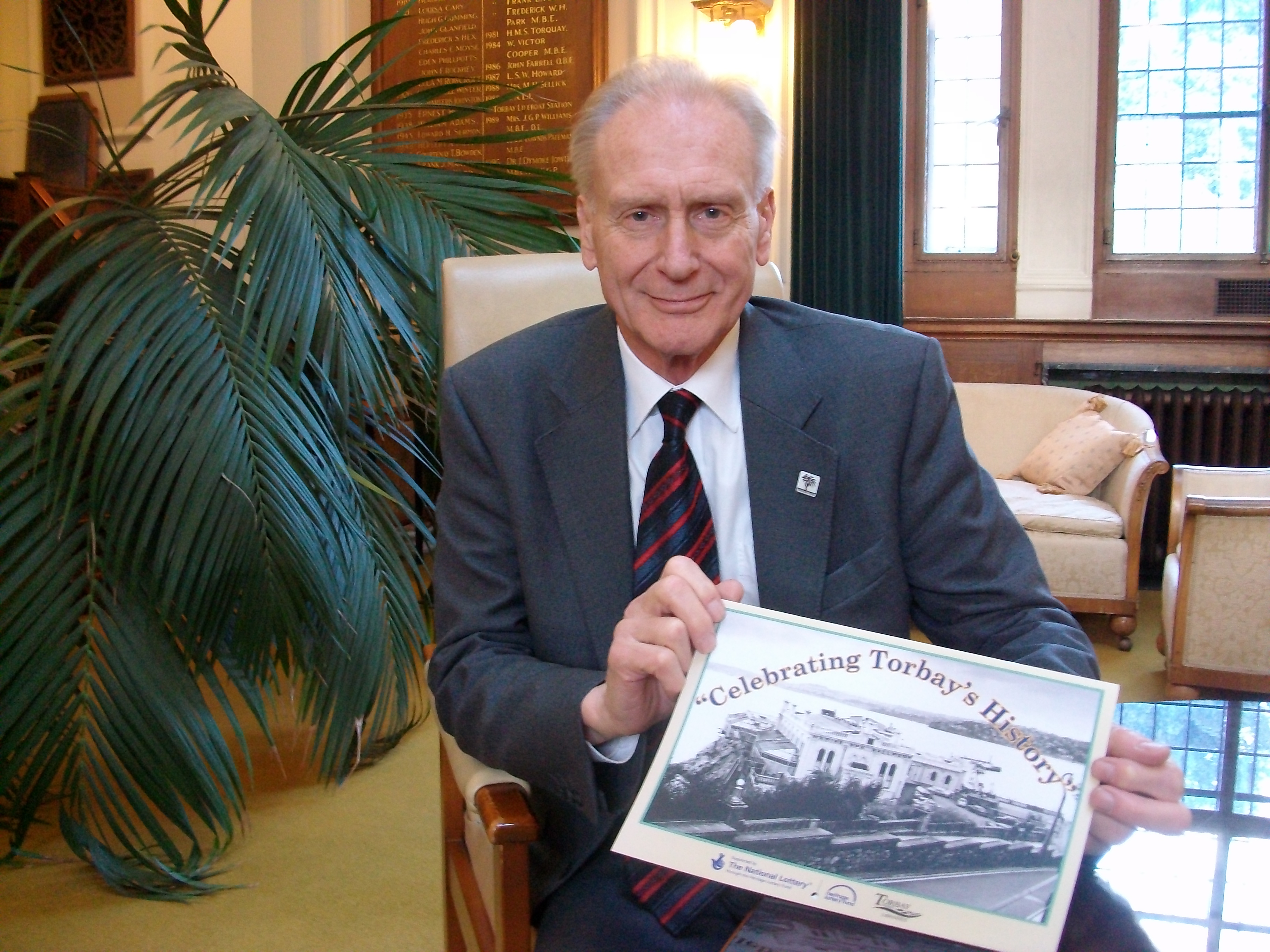 Mayor showing the Celebrating Torbay calendar