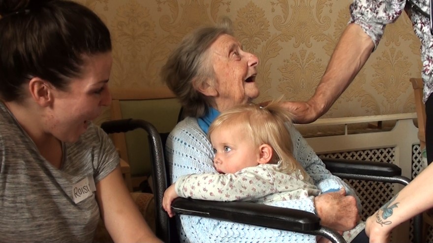 Girl cuddling female resident