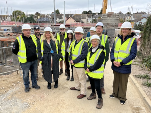 Group of people wearing hard heads and high-vis jackets visiting the St Kilda redevelopment site.