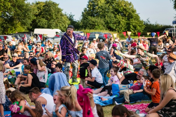Summer Theatre taking place outside Torre Abbey, with a crowd